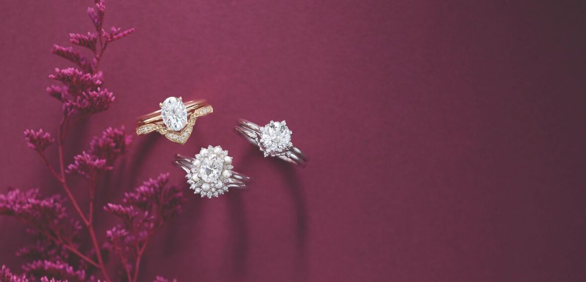 White and yellow gold diamond wedding bands styled on lace fabric, showcasing elegant bridal ring designs by Wedding Bands & Co. in Chicago