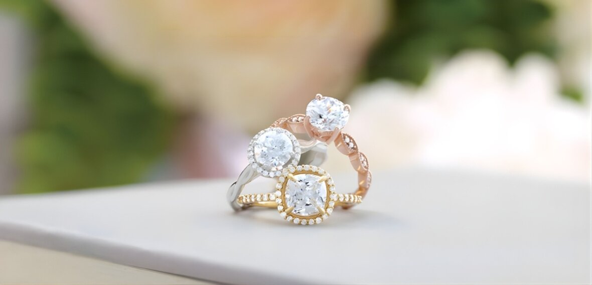 White and yellow gold diamond engagement rings showing cultural variations in ring finger placement