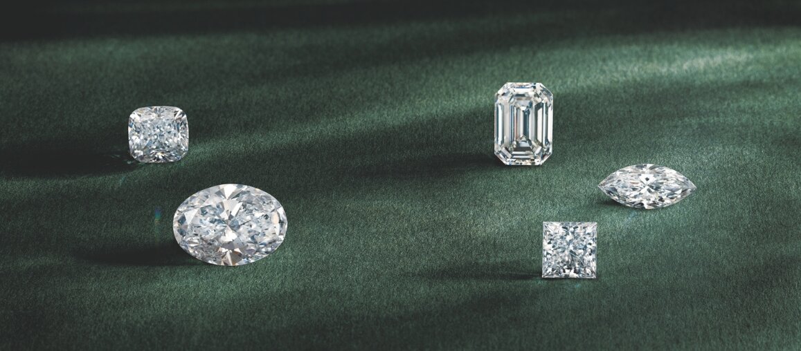 Vertical display of wedding bands in platinum, white gold, yellow gold, and rose gold showing metal options by Wedding Bands & Co. in Chicago