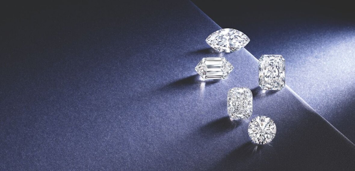 White and yellow gold diamond wedding bands styled on lace fabric, showcasing elegant bridal ring designs by Wedding Bands & Co. in Chicago