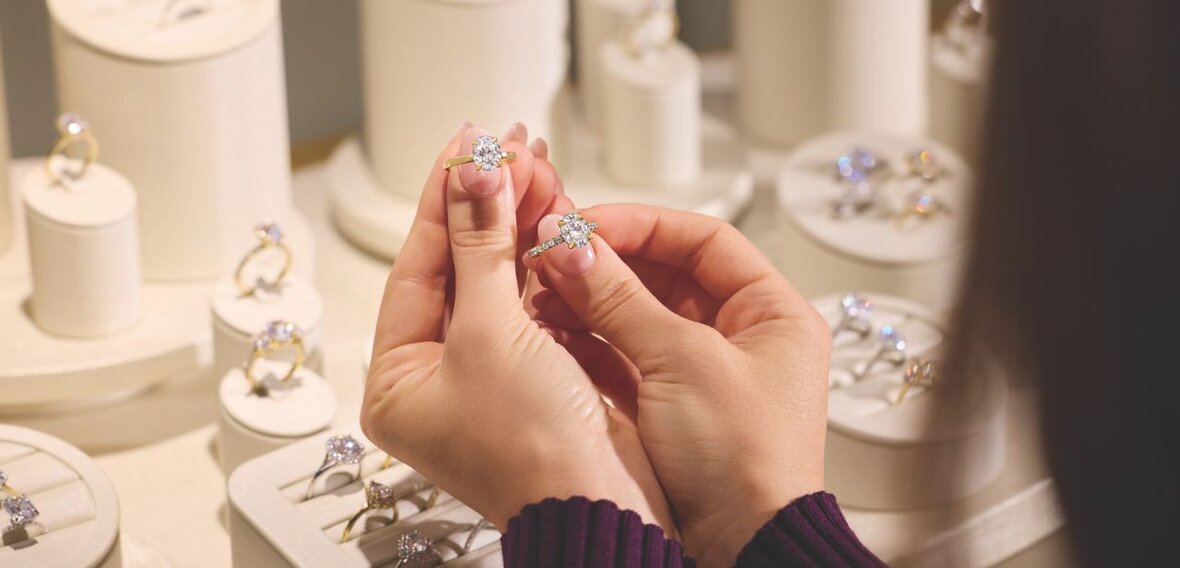 White and yellow gold diamond wedding bands styled on lace fabric, showcasing elegant bridal ring designs by Wedding Bands & Co. in Chicago