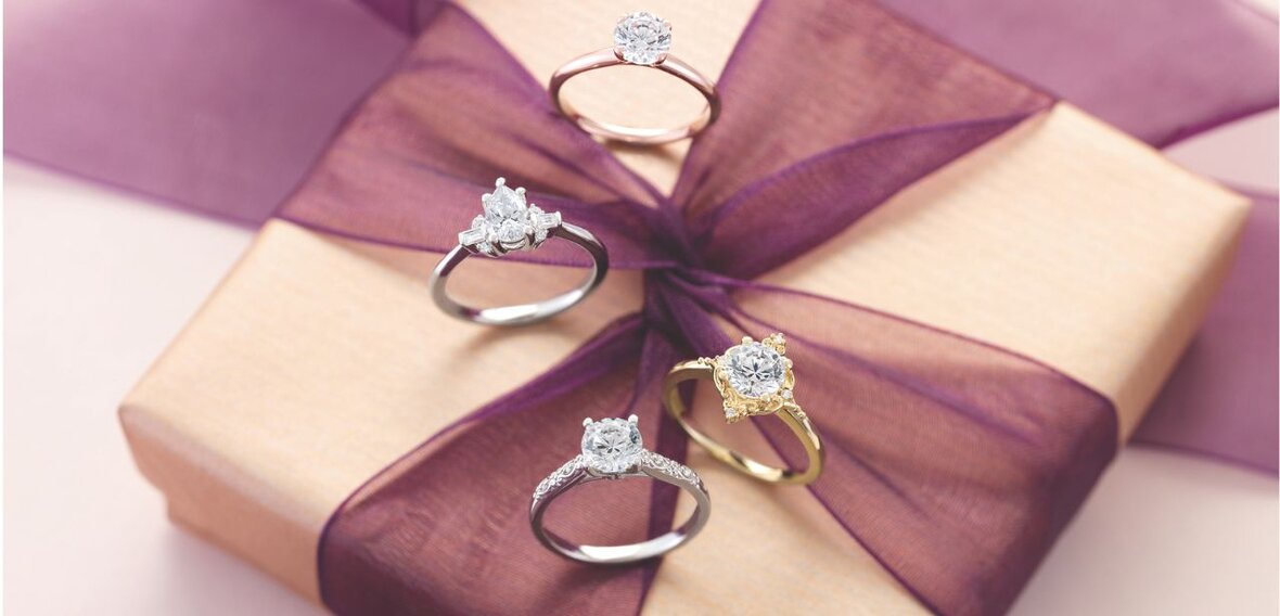 White and yellow gold diamond wedding bands styled on lace fabric, showcasing elegant bridal ring designs by Wedding Bands & Co. in Chicago