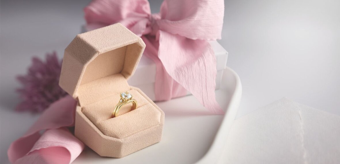 White and yellow gold diamond wedding bands styled on lace fabric, showcasing elegant bridal ring designs by Wedding Bands & Co. in Chicago