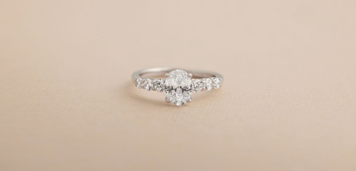 White and yellow gold diamond wedding bands styled on lace fabric, showcasing elegant bridal ring designs by Wedding Bands & Co. in Chicago