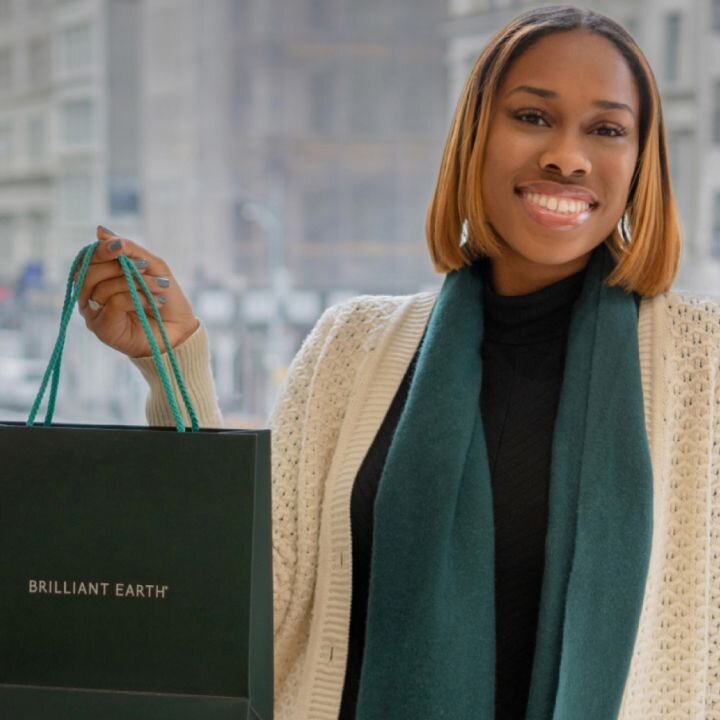 Person smiling holding shopping bag