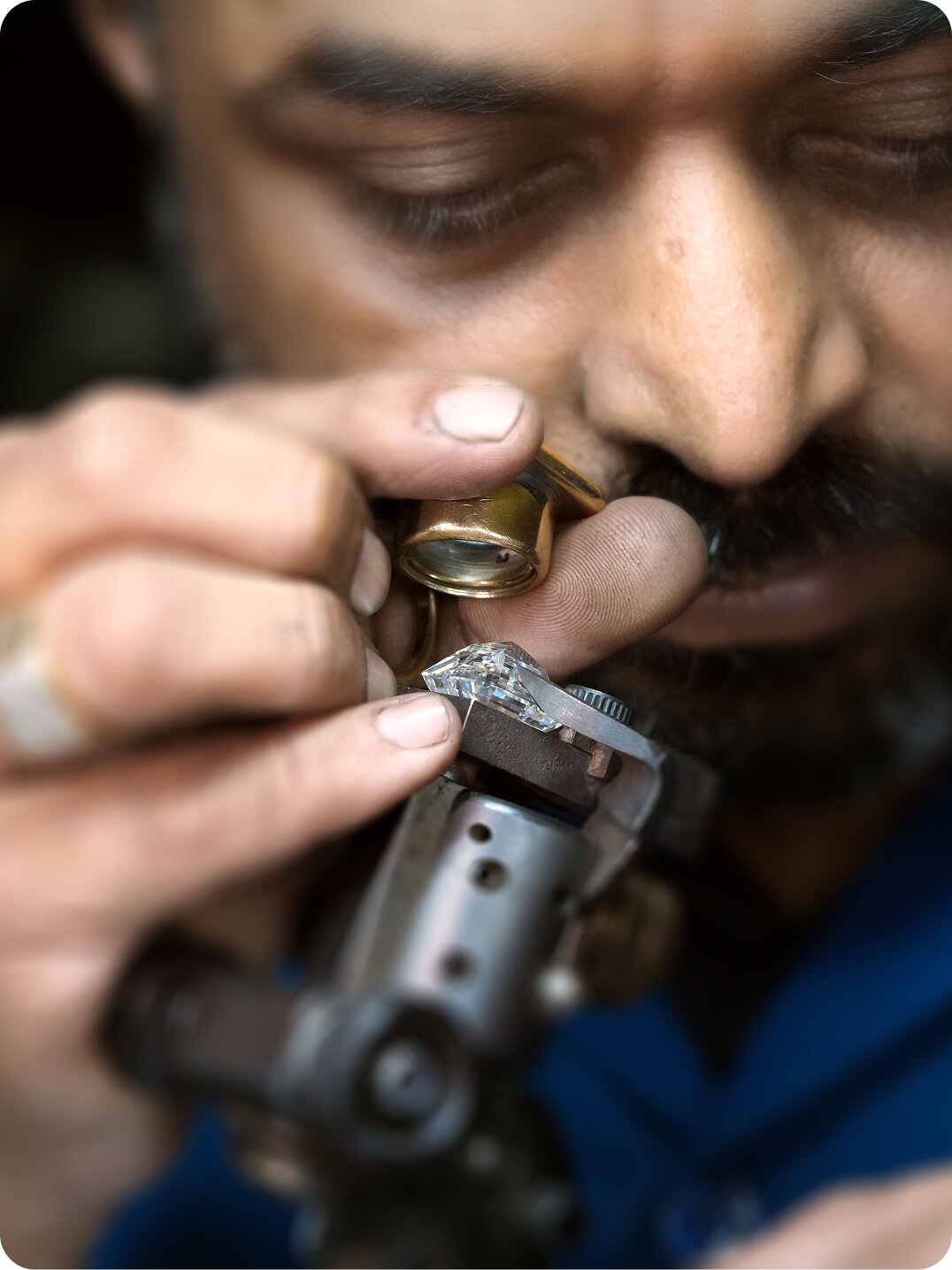 Diamond engagement ring with a large center stone in a detailed setting, photographed against a deep teal background