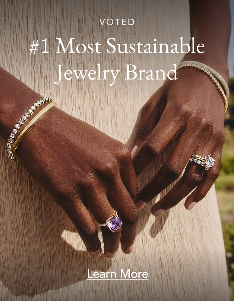 Model wearing assortment of diamond and gemstone fine jewelry.