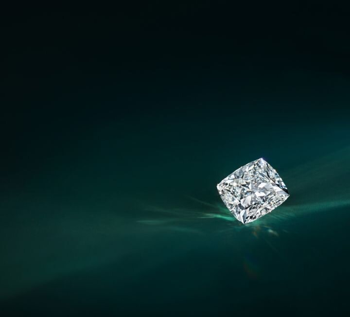 Geometric illustration of a diamond symbol in white against dark background