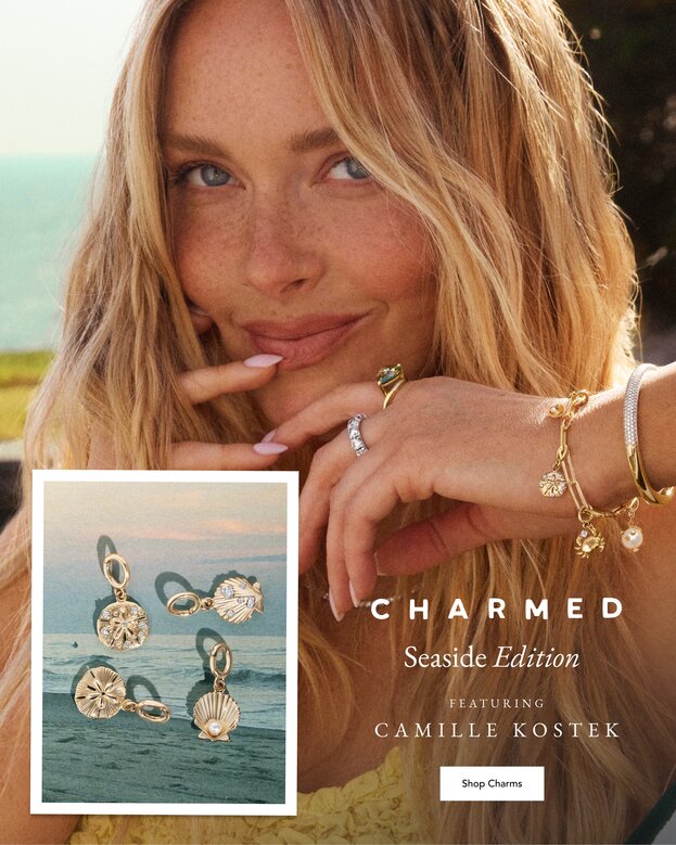 Camille Kostek wearing a gold charm bracelet perfect for Summer.