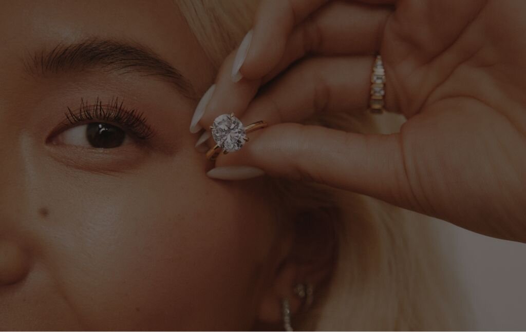 Close-up of someone's hand wearing a diamond engagement ring 