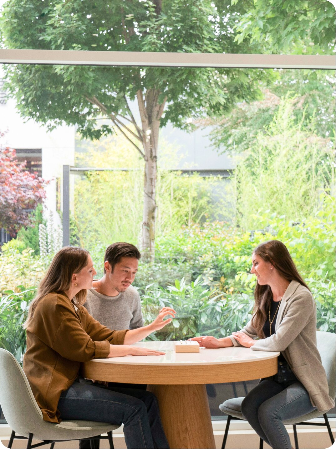 Bright Brilliant Earth retail showroom interior with wooden furniture and large windows with greenery outside