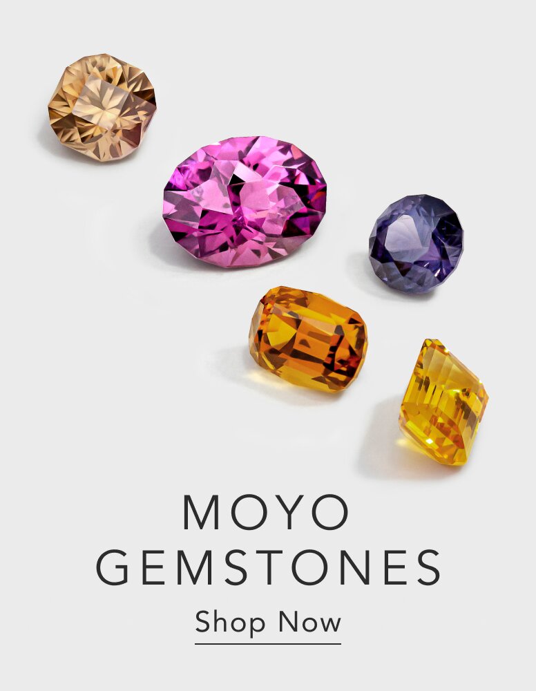 Assortment of loose colored gemstones.