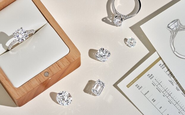 Assortment of loose diamonds and diamond engagement rings