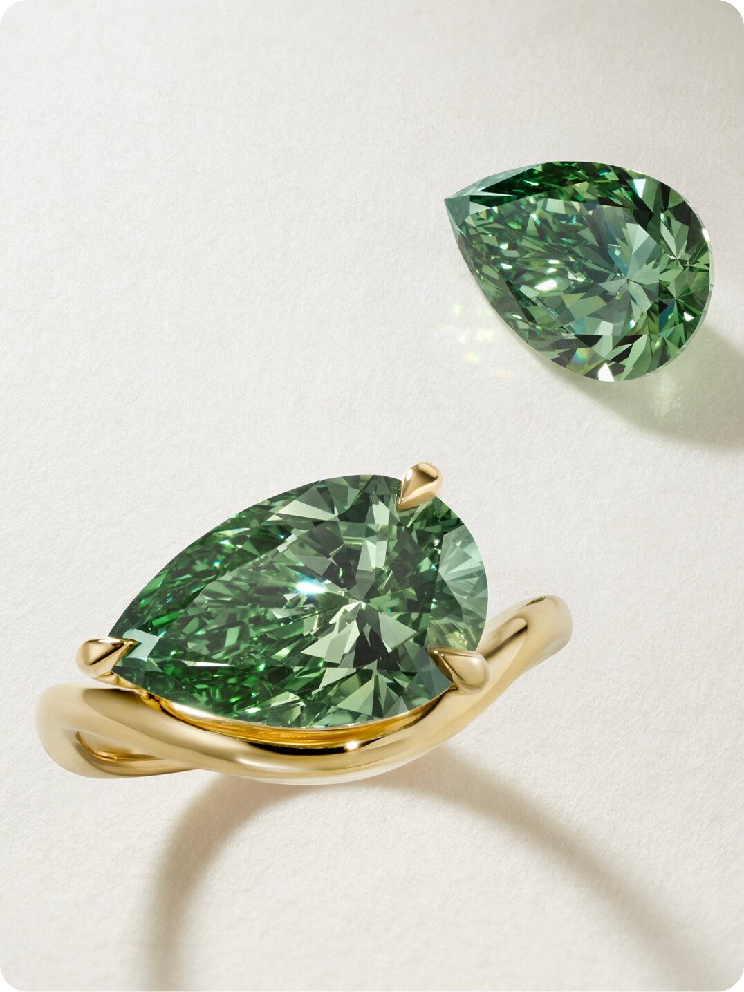 Multiple loose lab-grown diamonds displayed on a light purple or white surface