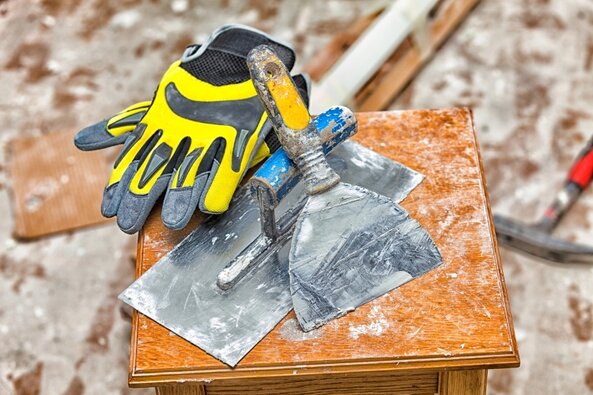 Drywall tools with gloves on table