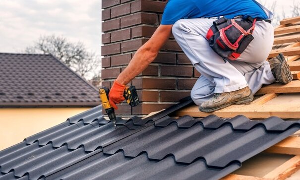 Worker repairing roof