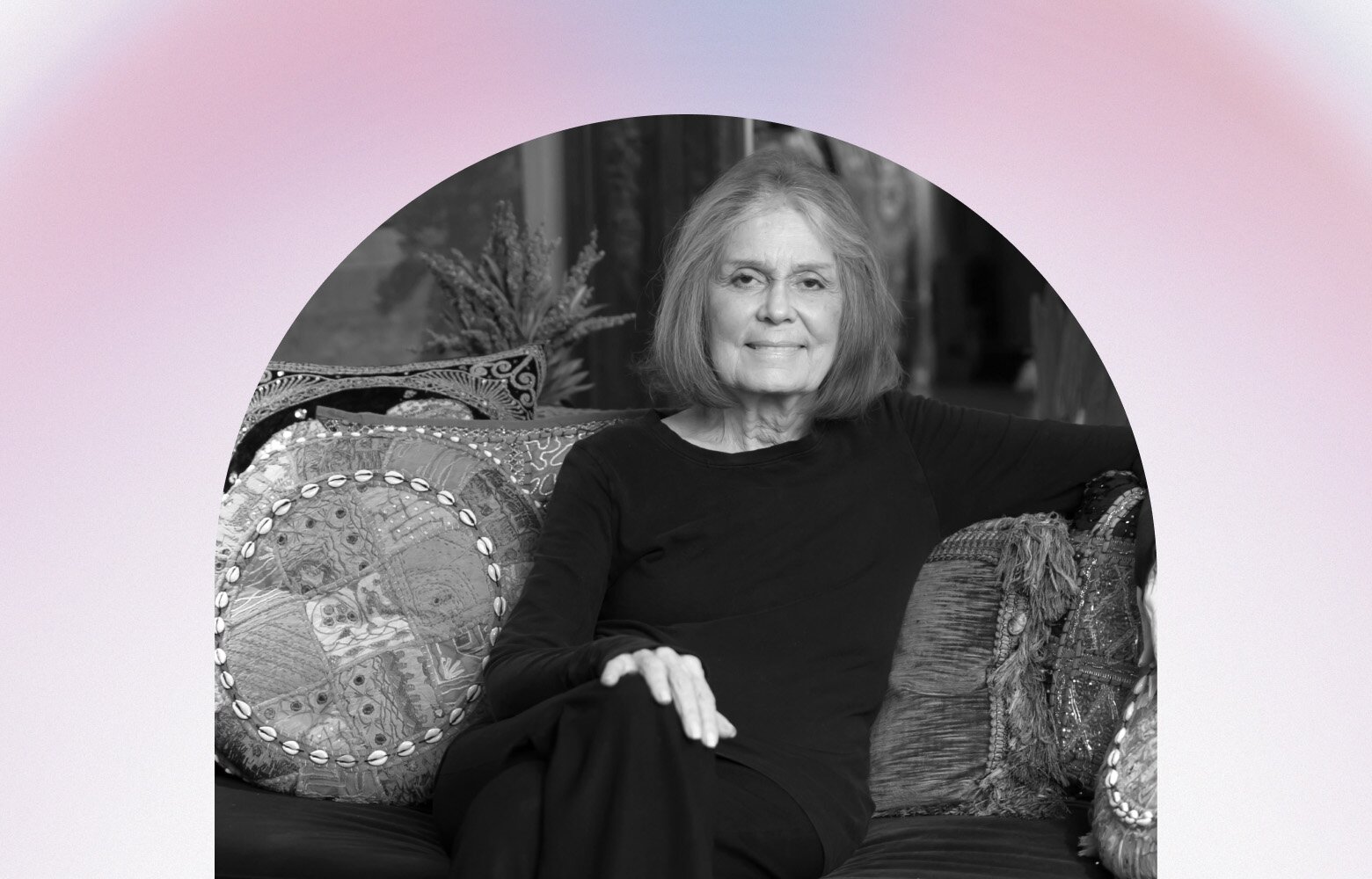 Gloria Steinem sitting on a couch
