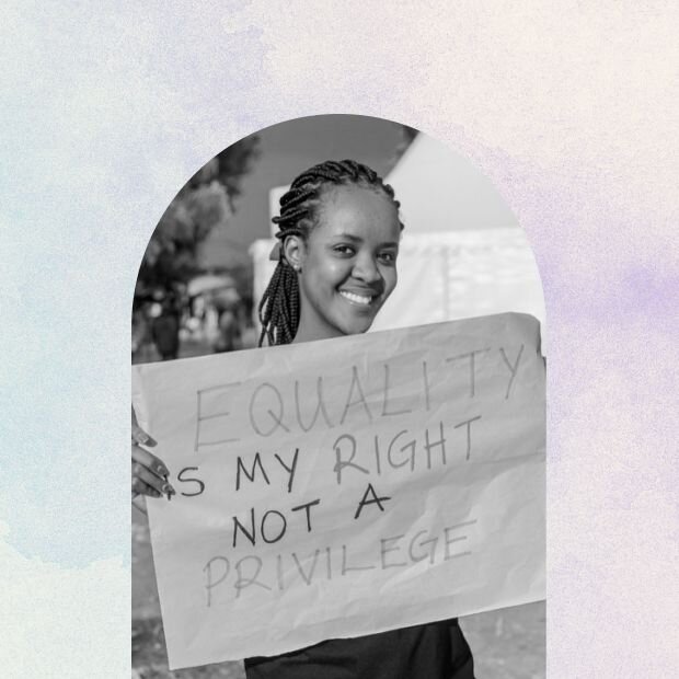A young woman holding up a poster about equal rights
