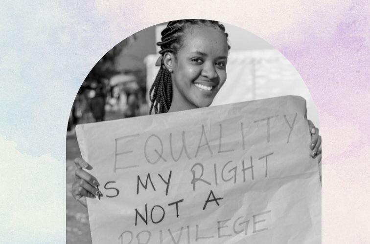 A young woman holding up a poster about equal rights