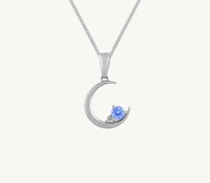 An ice blue and white sapphire crescent moon pendant in sterling silver