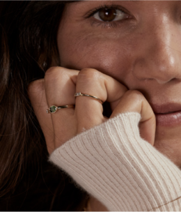 A woman wearing several fashion rings