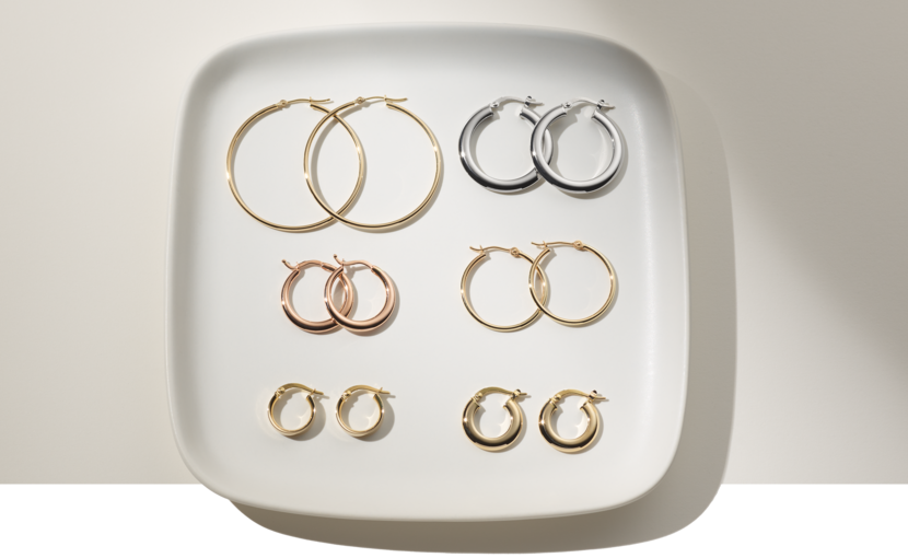 Six pairs of hoop earrings on a plate