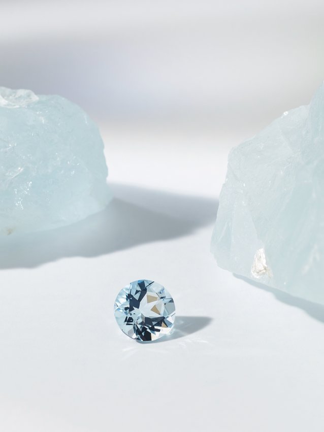 image of raw and cut aquamarine gemstone