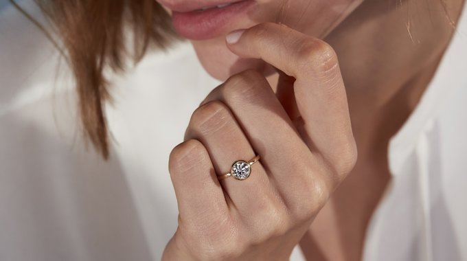 A woman wearing a diamond engagement ring