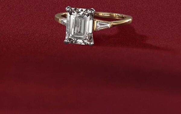 Two engagement rings on a festive red background