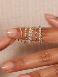 A woman wearing a stack of fashion rings