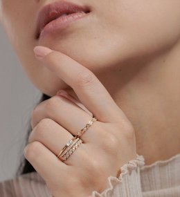 A woman wearing stackable fashion rings