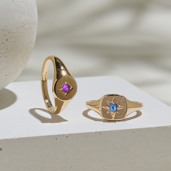 Two signet rings with colored gemstones in the center