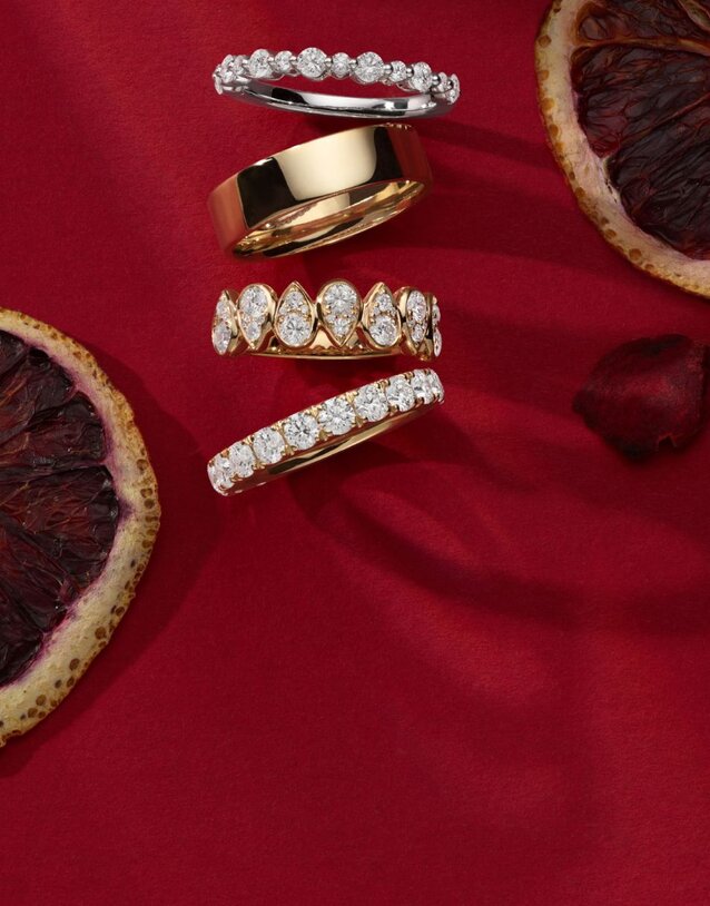 Four wedding bands on a red background