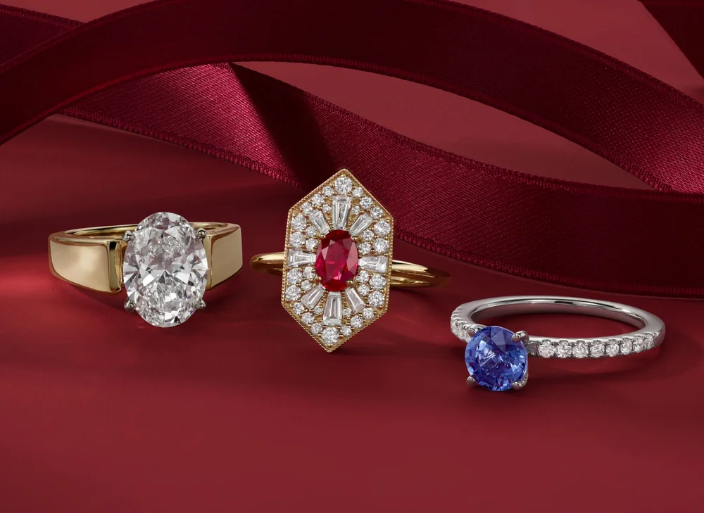 Three engagement rings on a red background.