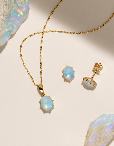 image of raw opal stone with an opal pendant and stud earrings