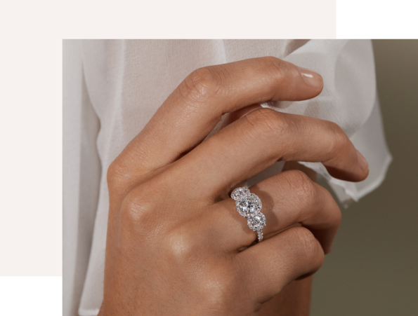 A woman's hand wearing a diamond engagement ring