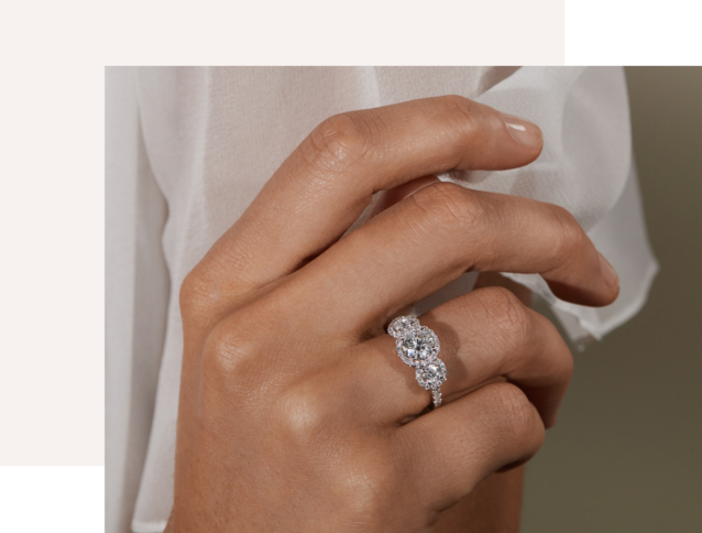 A woman's hand wearing a diamond engagement ring