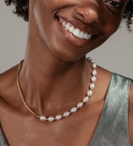 A woman wearing a pearl necklace