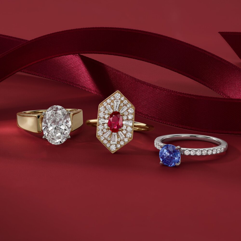 Three engagement rings on a red background.