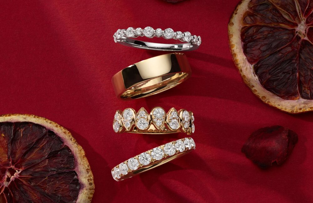 Four wedding bands on a red background