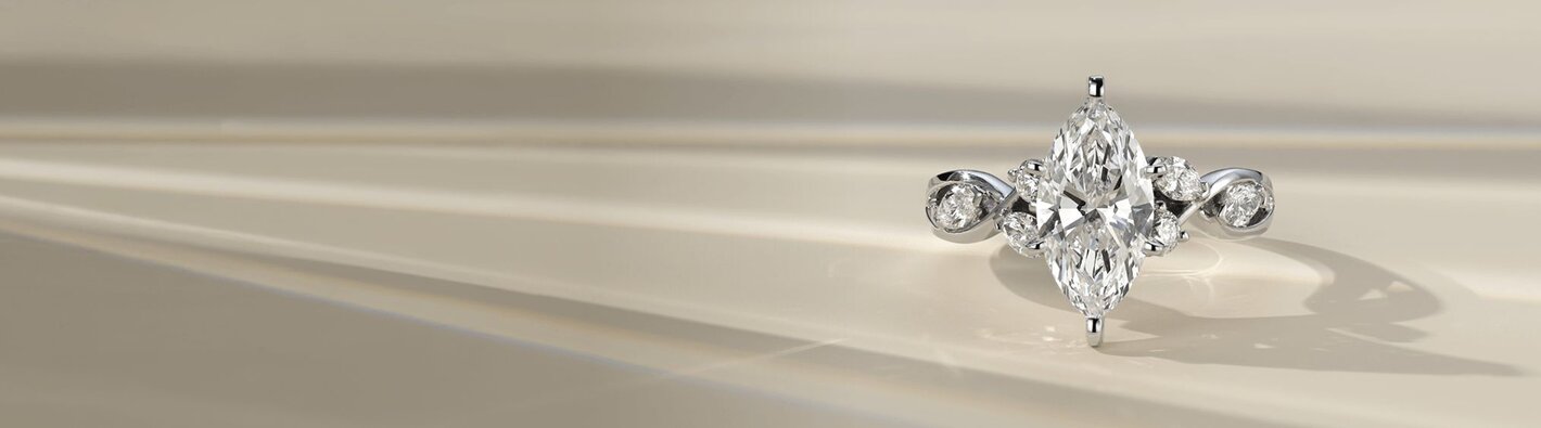 A diamond engagement ring with a marquise shape center stone