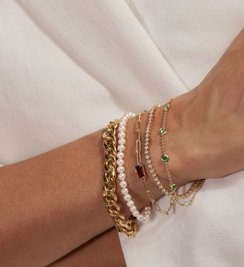 A woman wearing a collection of bracelets