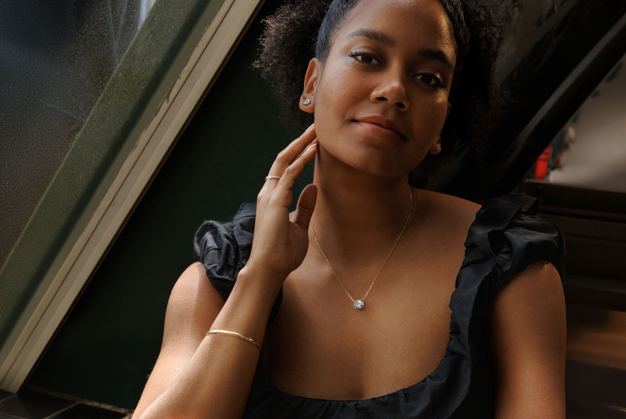 A woman wearing a collection of blue jewelry