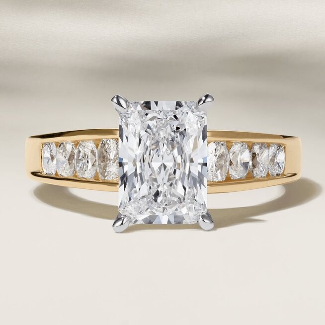 A diamond engagement ring with a cushion cut center diamond