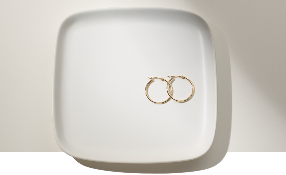 A pair of hoop earrings on a plate