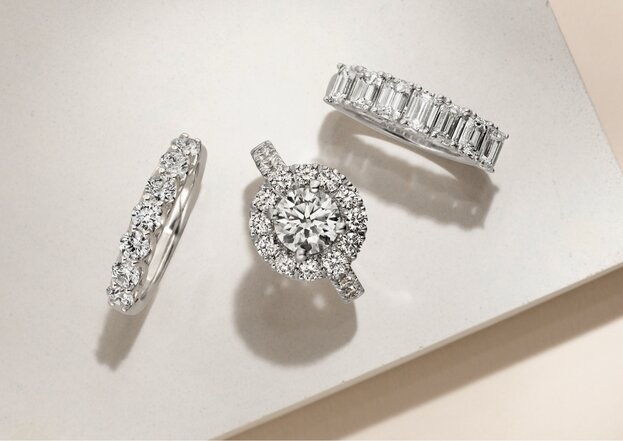 A diamond engagement ring and two wedding bands