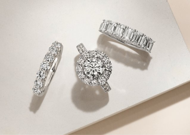 A diamond engagement ring and two wedding bands