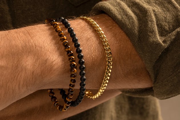 A man wearing three bracelets