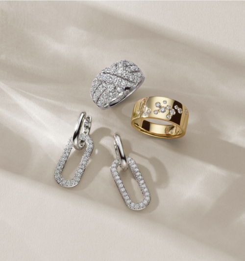 Two diamond fashion rings and a pair of diamond earrings