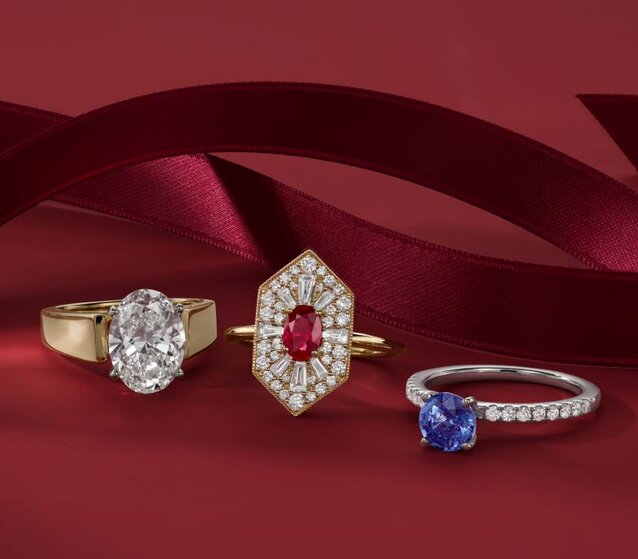 Three engagement rings on a red background.